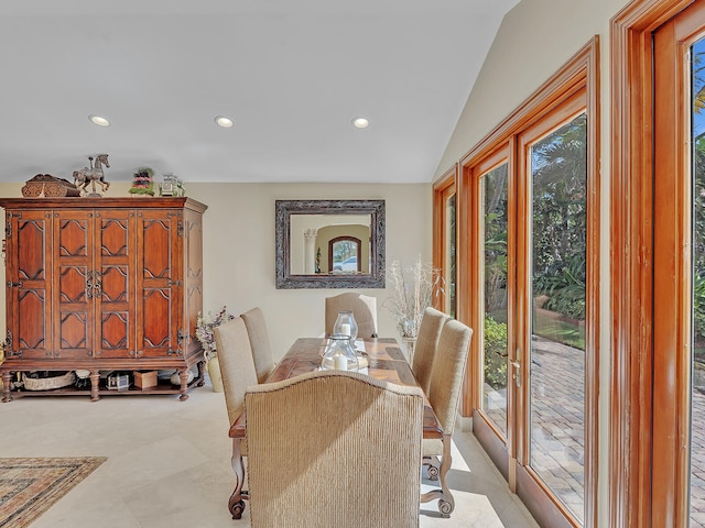 dining area featuring vaulted ceiling