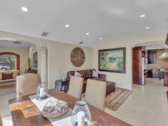 dining area with ornate columns and lofted ceiling