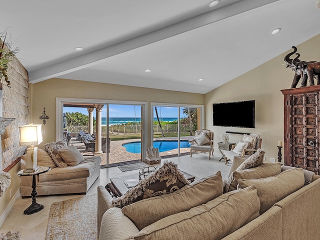 living room with vaulted ceiling with beams, light tile patterned floors, and a wealth of natural light