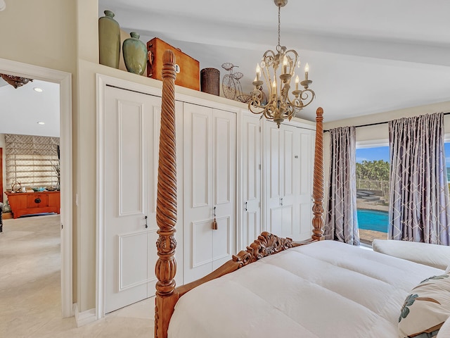 bedroom with light tile patterned flooring, lofted ceiling, and a notable chandelier