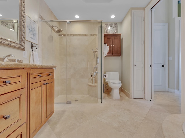 bathroom featuring vanity, toilet, and a shower with shower door