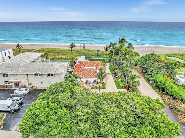 birds eye view of property with a water view and a view of the beach