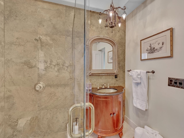 bathroom with a chandelier, vanity, and a shower with shower door