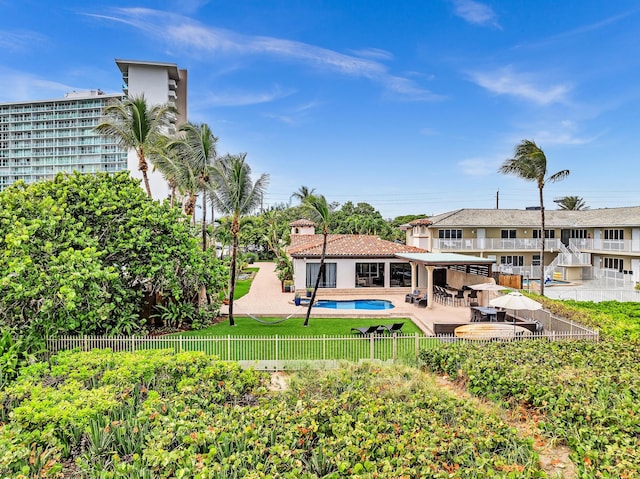 view of swimming pool featuring a lawn and a patio area