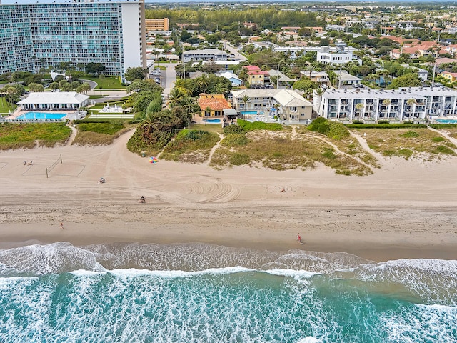 birds eye view of property featuring a water view and a view of the beach