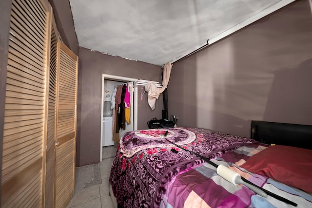 bedroom with light tile patterned floors and a closet