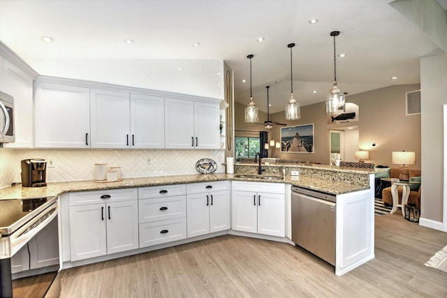 kitchen featuring pendant lighting, white cabinets, kitchen peninsula, and appliances with stainless steel finishes