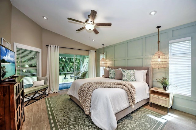 bedroom with light wood-type flooring, vaulted ceiling, and ceiling fan