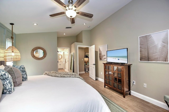 bedroom with lofted ceiling, light hardwood / wood-style floors, ceiling fan, and ensuite bathroom