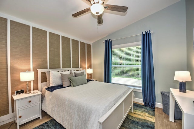 bedroom featuring lofted ceiling, ceiling fan, and hardwood / wood-style flooring