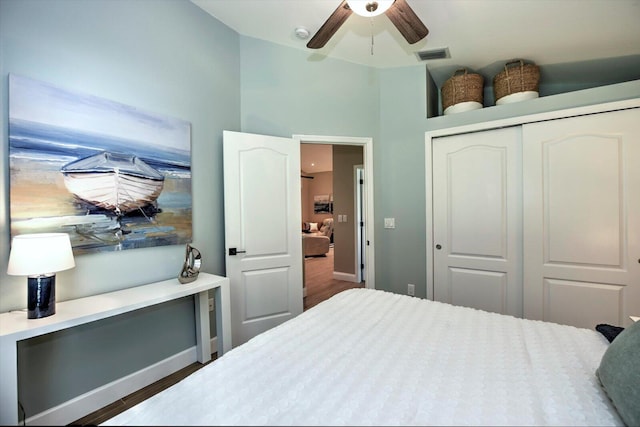 bedroom with ceiling fan, a closet, and dark hardwood / wood-style floors