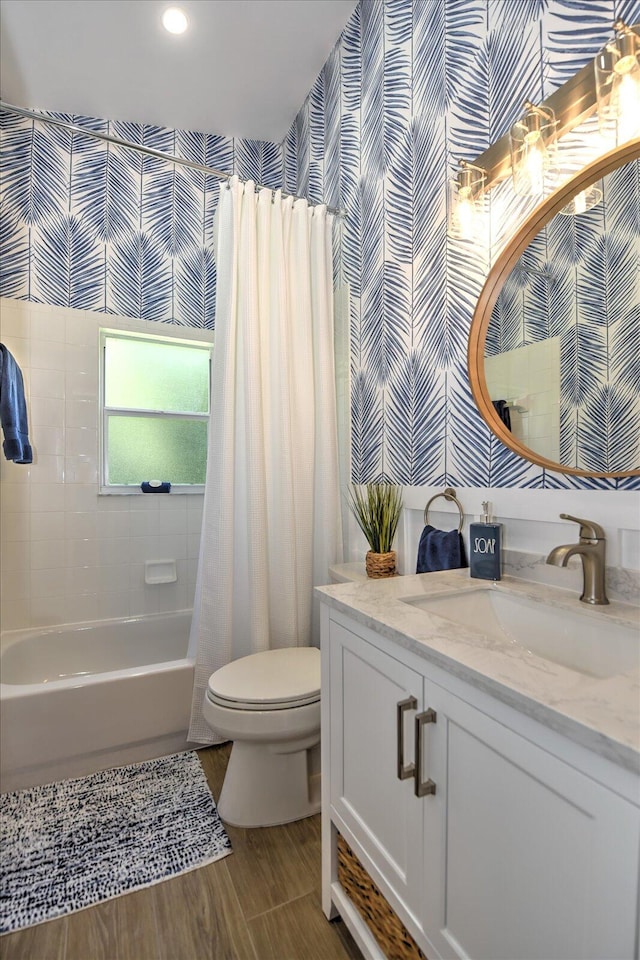 full bathroom featuring wood-type flooring, vanity, toilet, and shower / bathtub combination with curtain