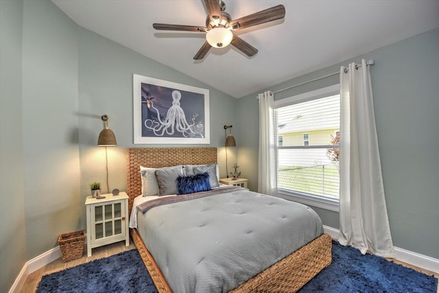 bedroom featuring ceiling fan, hardwood / wood-style flooring, and lofted ceiling