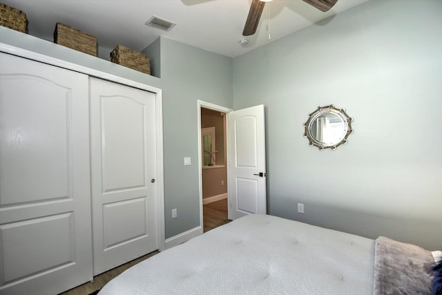 bedroom featuring hardwood / wood-style flooring, ceiling fan, and a closet