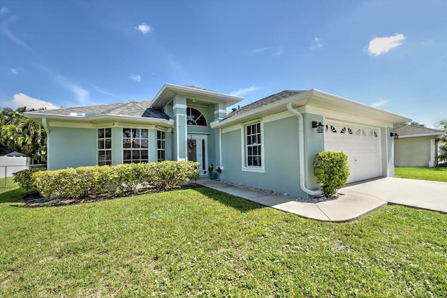 view of front of property featuring a front yard and a garage