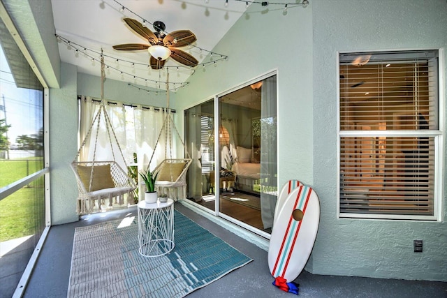 sunroom / solarium featuring vaulted ceiling, ceiling fan, and a healthy amount of sunlight