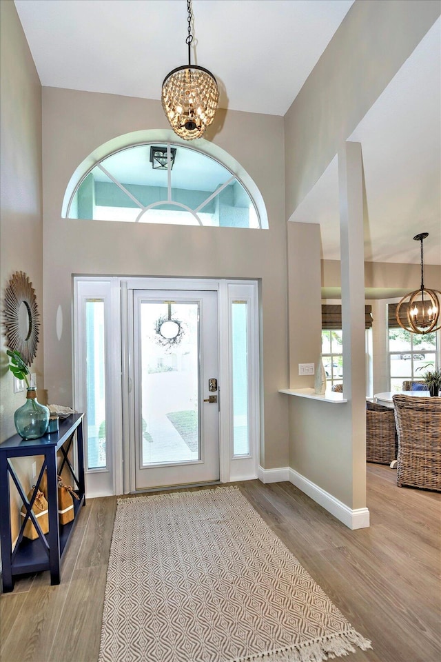 entrance foyer with an inviting chandelier and light hardwood / wood-style floors