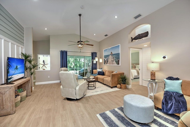 living room with light wood-type flooring, ceiling fan, and high vaulted ceiling