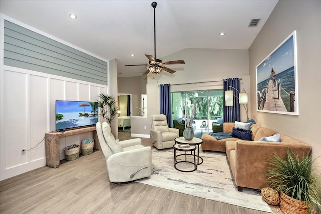 living room with wood-type flooring, lofted ceiling, and ceiling fan