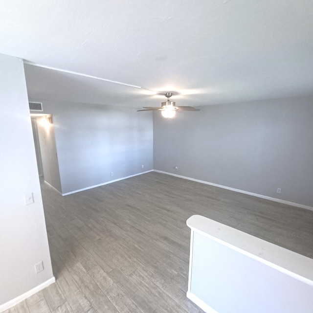 empty room featuring ceiling fan and hardwood / wood-style floors