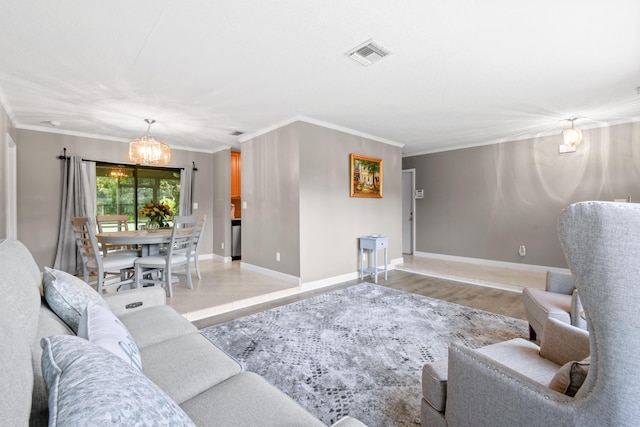 living room featuring a notable chandelier, crown molding, and light hardwood / wood-style flooring