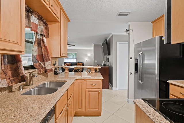 kitchen featuring sink, light brown cabinetry, light stone counters, kitchen peninsula, and stainless steel appliances