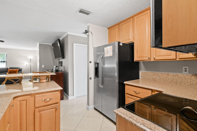 kitchen featuring stainless steel refrigerator with ice dispenser, light stone counters, a textured ceiling, light tile patterned floors, and light brown cabinets