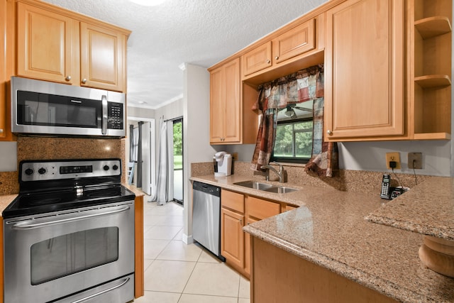 kitchen featuring light brown cabinets, crown molding, sink, appliances with stainless steel finishes, and light tile patterned flooring