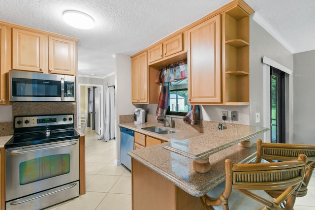 kitchen featuring light brown cabinetry, ornamental molding, stainless steel appliances, sink, and light tile patterned floors