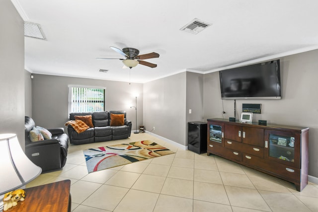 tiled living room with ceiling fan and ornamental molding