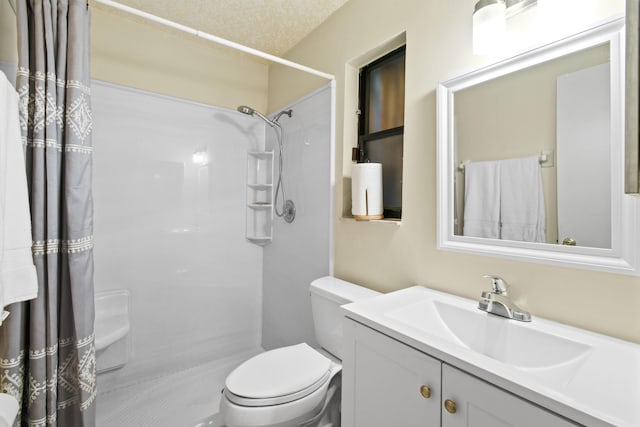 bathroom with vanity, toilet, and walk in shower