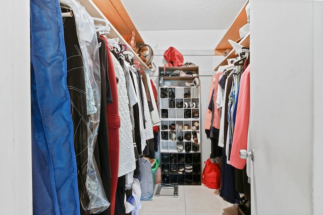 spacious closet with light tile patterned floors