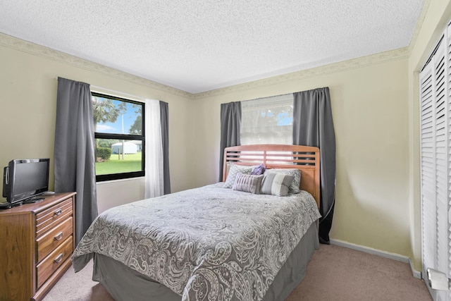 carpeted bedroom featuring a closet and a textured ceiling