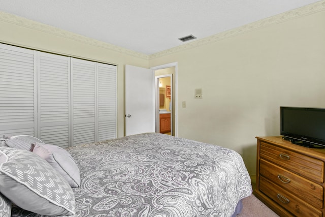 carpeted bedroom featuring a closet and a textured ceiling