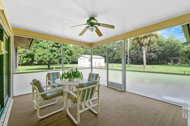 sunroom / solarium featuring ceiling fan