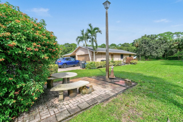 view of yard with a patio and a garage