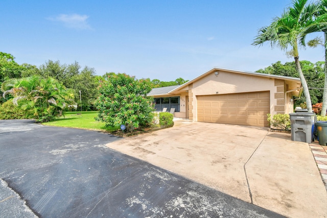 ranch-style home with a front yard and a garage