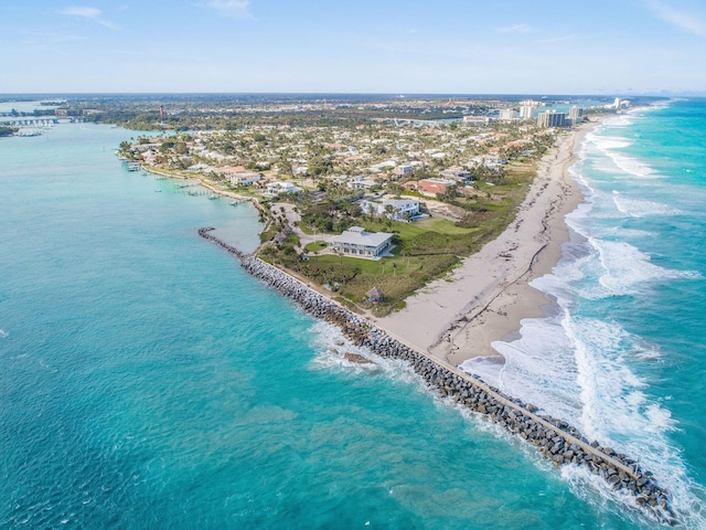 drone / aerial view with a water view and a beach view