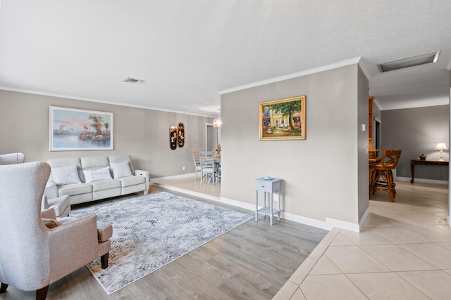 living room with ornamental molding and light hardwood / wood-style flooring