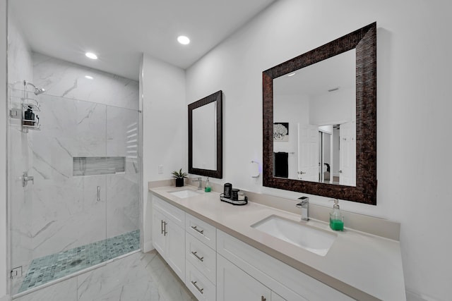 bathroom with a shower with door and vanity