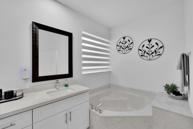 bathroom featuring tiled bath and vanity