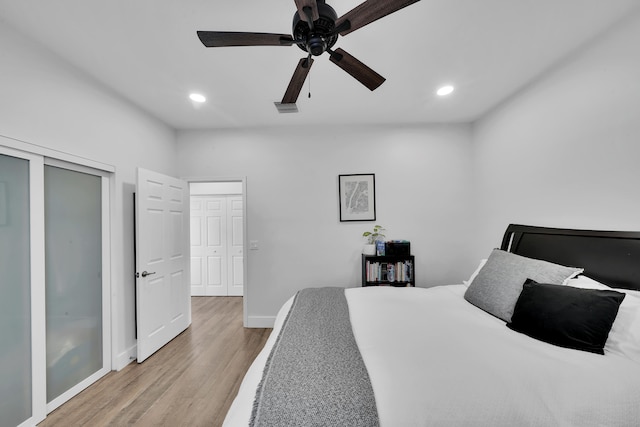 bedroom featuring ceiling fan, a closet, and light hardwood / wood-style floors