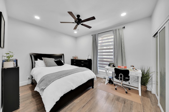 bedroom featuring ceiling fan, a closet, and hardwood / wood-style flooring