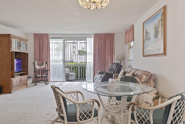 dining space featuring carpet floors and a chandelier