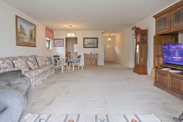 living room featuring light colored carpet and a chandelier