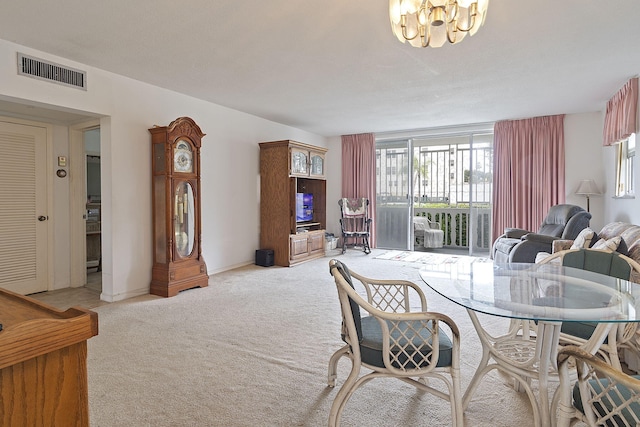 carpeted dining space featuring a chandelier