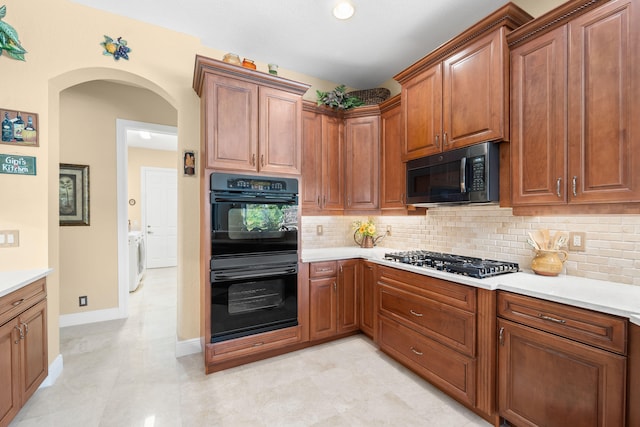 kitchen featuring independent washer and dryer, tasteful backsplash, and appliances with stainless steel finishes