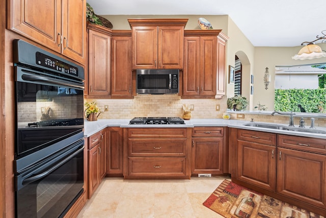 kitchen with backsplash, black appliances, sink, and light tile patterned floors