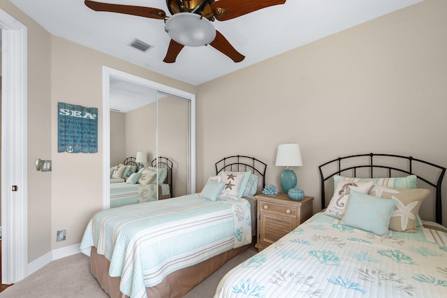 bedroom featuring a closet, ceiling fan, and light carpet