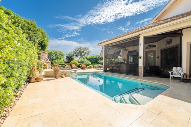 view of pool with a patio, a fireplace, and ceiling fan